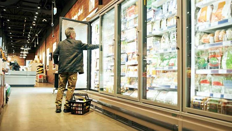 Shot of a mature man selecting frozen items in a supermarket