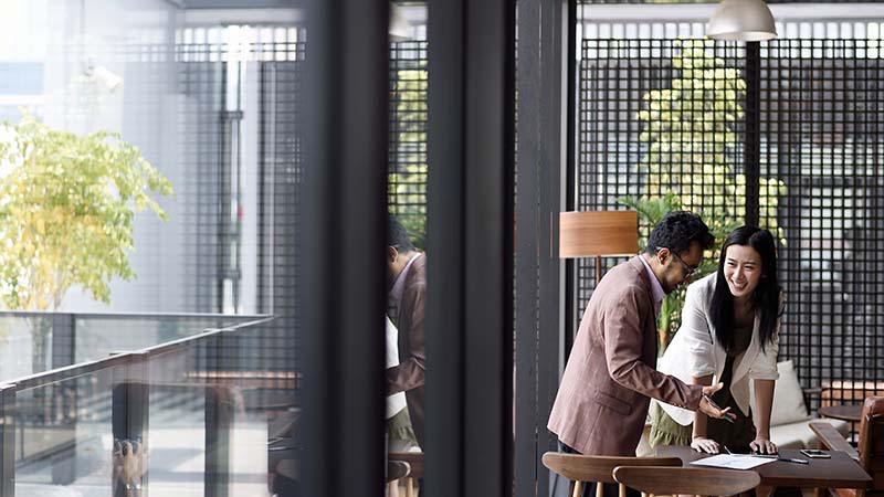 JLL employees having a conversation while working inside the office building