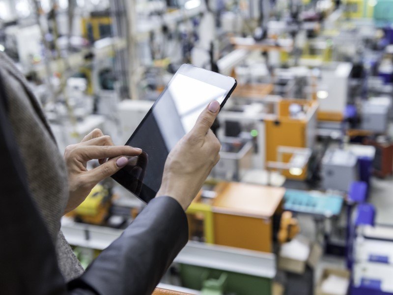 Man in the warehouse using tablet to check the stocks