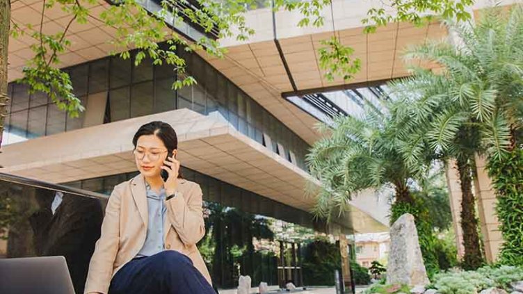 Women working in a laptop and having a call in mobile
