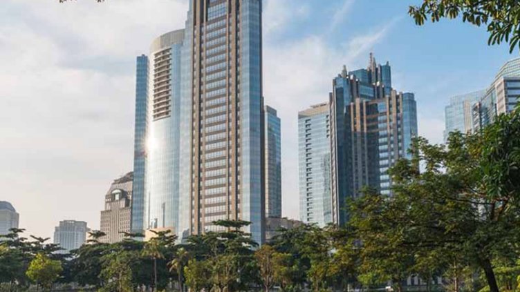 Public park surrounded by tall buildings in Jakarta, Indonesia