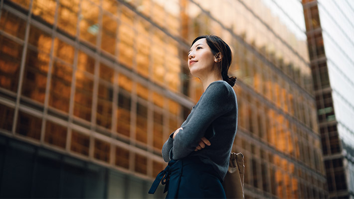 A girl standing with Jakarta building