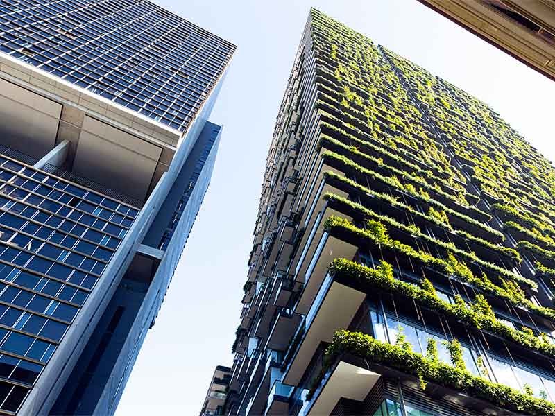 Low angle view of apartment building with vertical garden, sky background with copy space, Green wall-BioWall or living wall is a wall covered with living plants on residential tower in sunny day, Sydney Australia, full frame horizontal composition