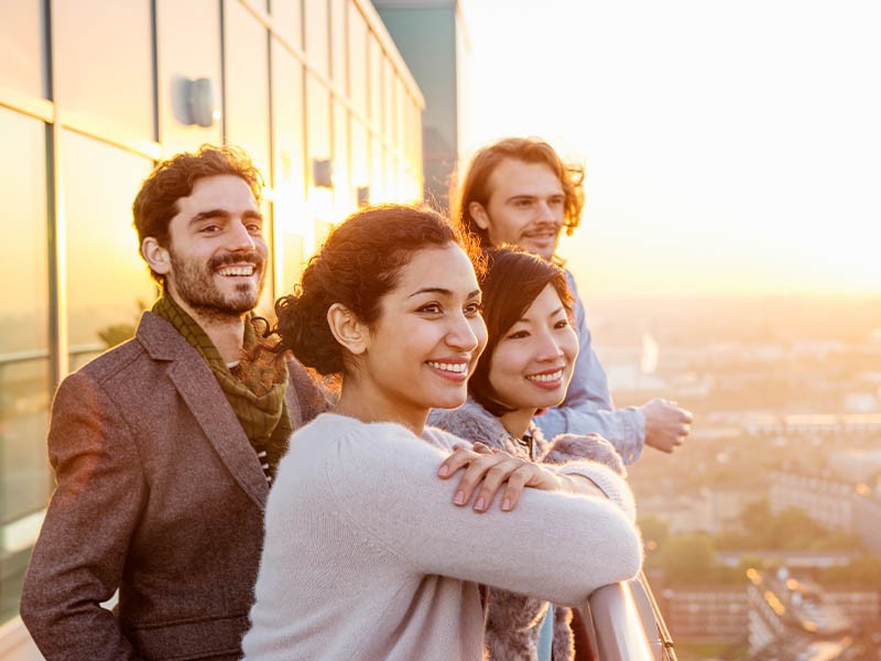 Group of friends standing on the balcony