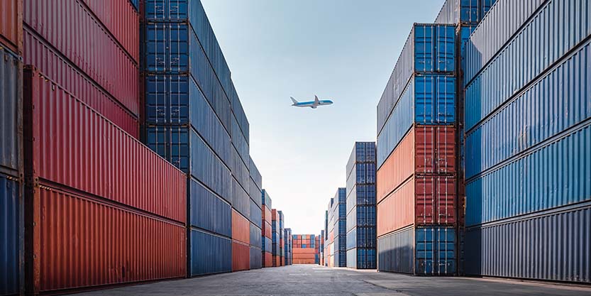 Aeroplane at the background in a container yard