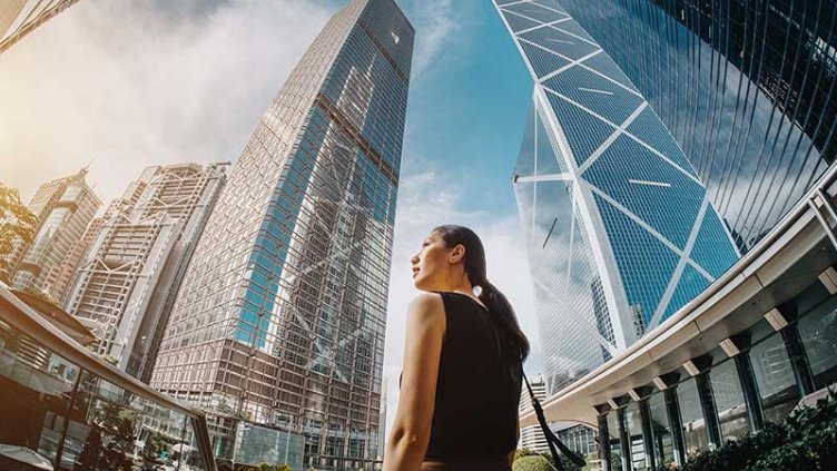 A women standing in the center of commercial building surrounding her