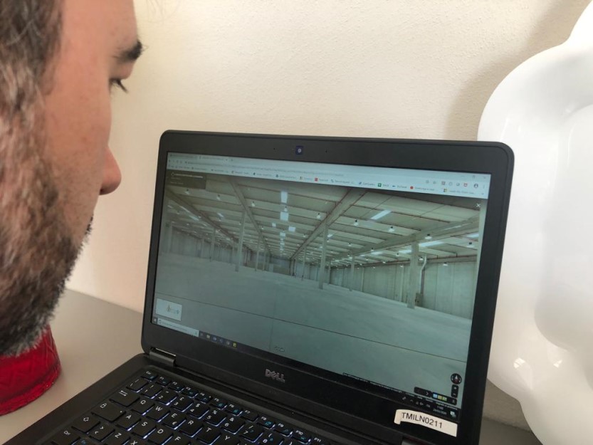 Man assessing the warehouse site remotely from home