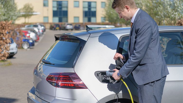 Man charging his electric car