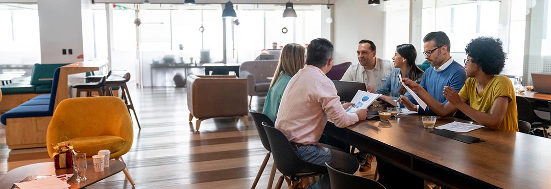 Team meeting in a modern office with multiple types of furniture