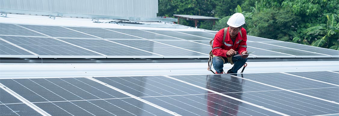 Maintenance engineer inspecting solar panels