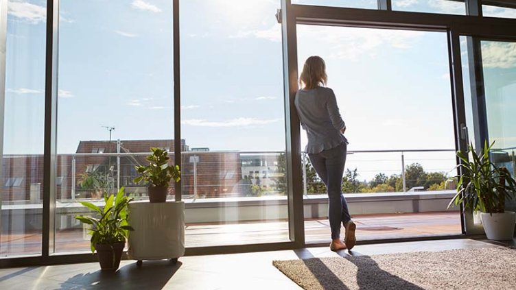 A woman standing and looking outside