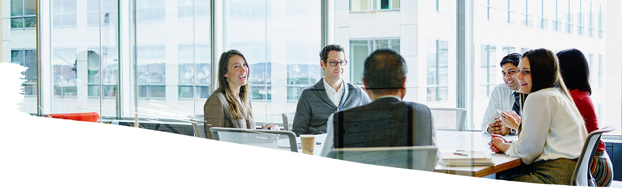 Employees having conversation inside a meeting room in the office building