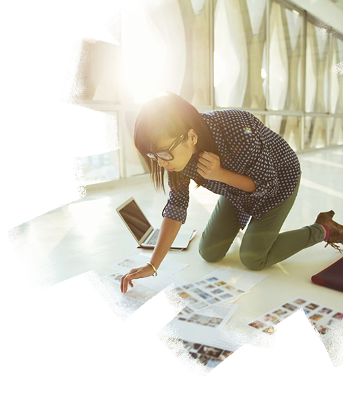 A woman working while sitting on the floor